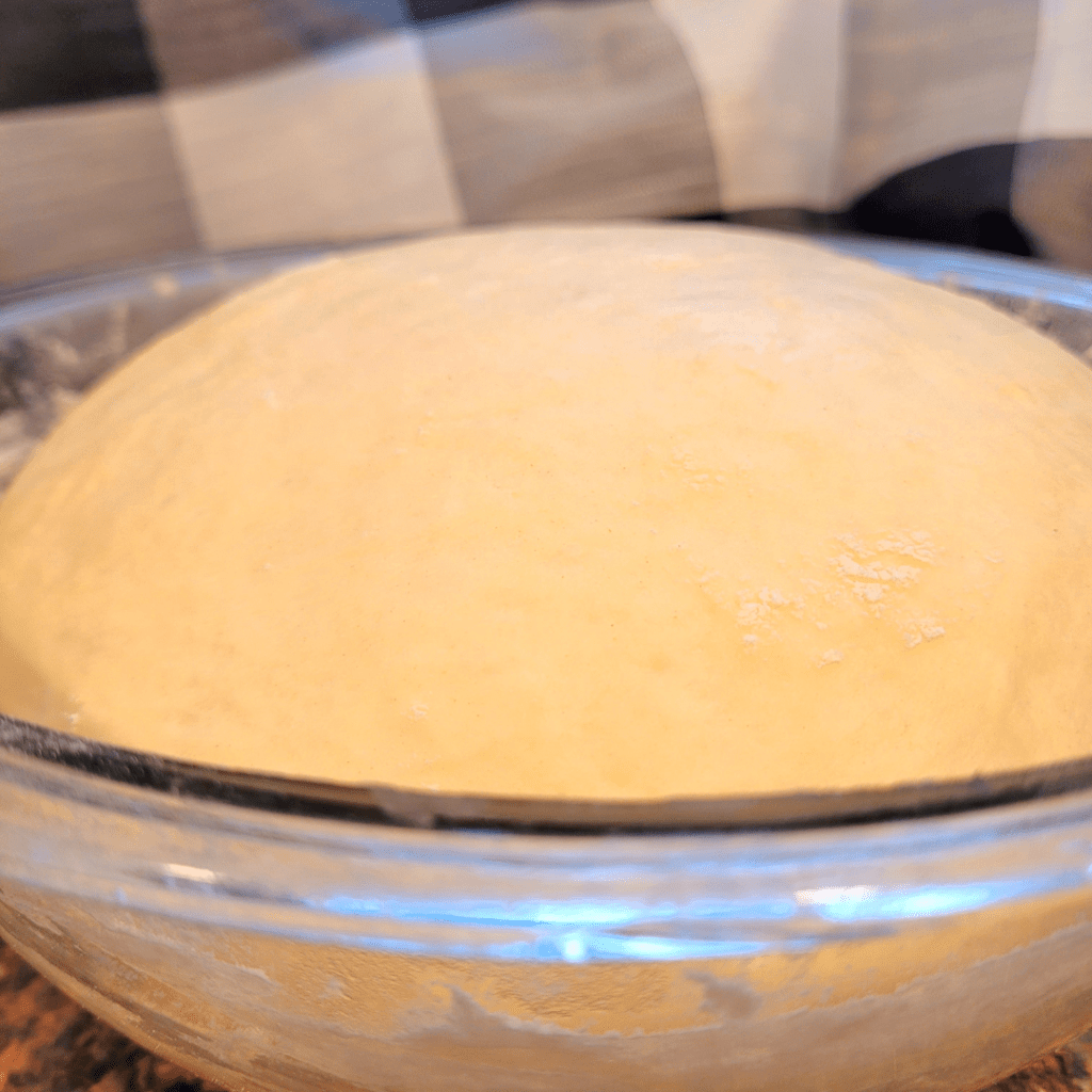 Image illustrates dough for white bread recipe for beginners.
