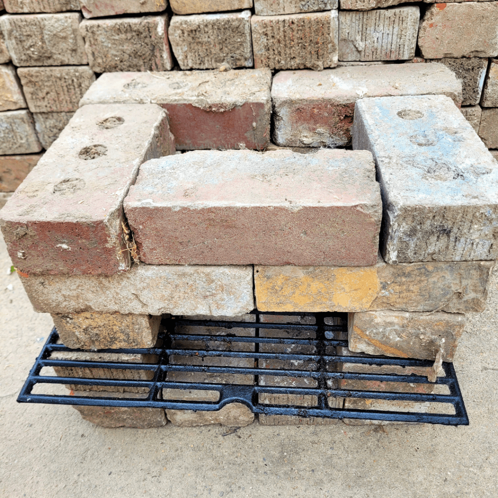 Image illustrates an off-grid rocket stove building tutorial. 