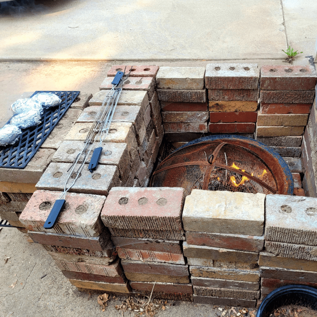 Image illustrates an off-grid rocket stove and fire pit. 