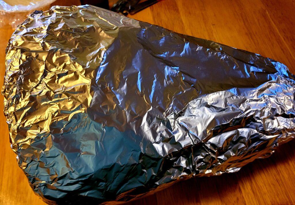 Image illustrates aluminum foil cornucopia mold showcasing a Thanksgiving breaded cornucopia recipe. 