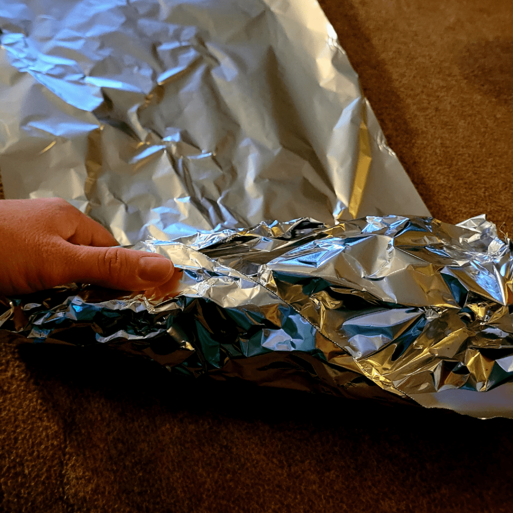 Image illustrates aluminum foil cornucopia mold showcasing a Thanksgiving breaded cornucopia recipe. 