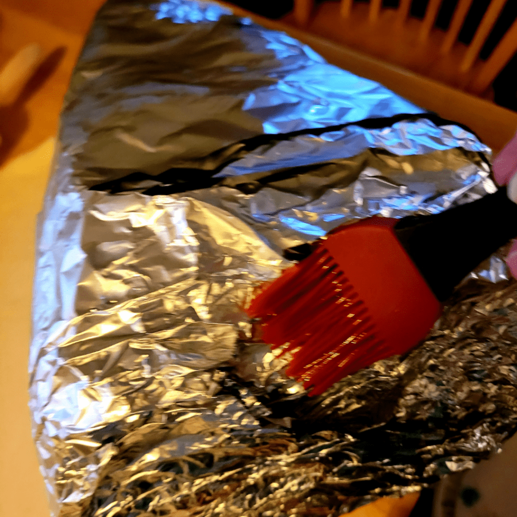 Image illustrates aluminum foil cornucopia mold showcasing a Thanksgiving breaded cornucopia recipe. 