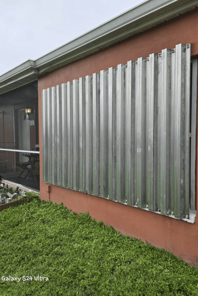 Image illustrates hurricane shutters from a house that survived hurricanes Ian and Milton.