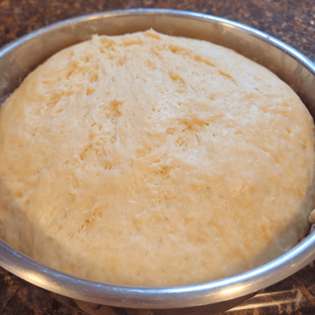 Image illustrates a dough ball for a 6 braided challah bread recipe.