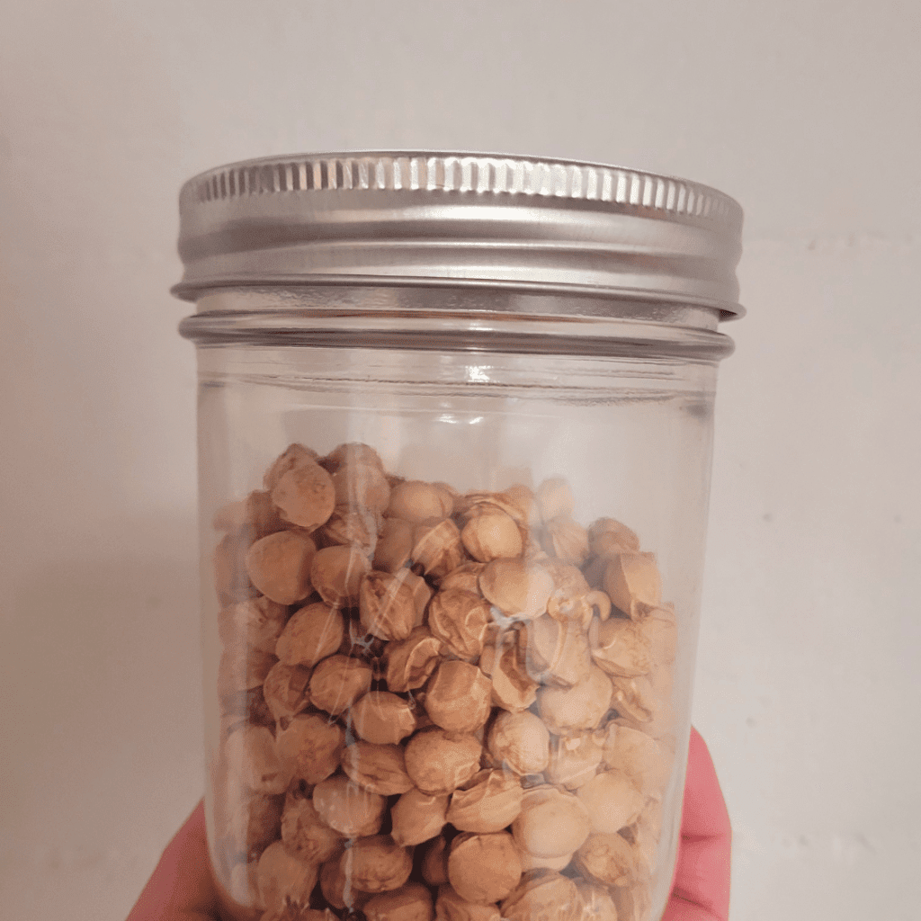 Image illustrates cherry pits in a jar.