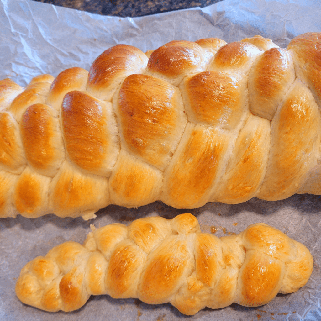 Image illustrates a 6 braided challah bread demonstrating how to braid a challah bread.
