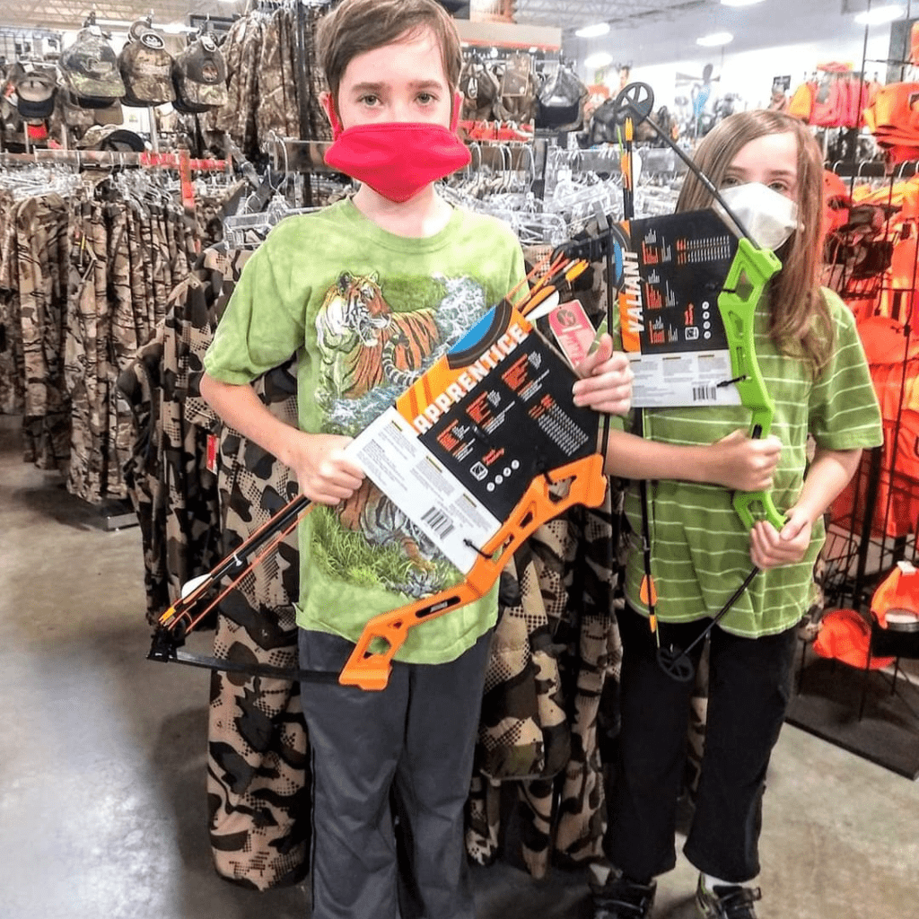 Image illustrates a kid with a bow and arrow for archery for kids.