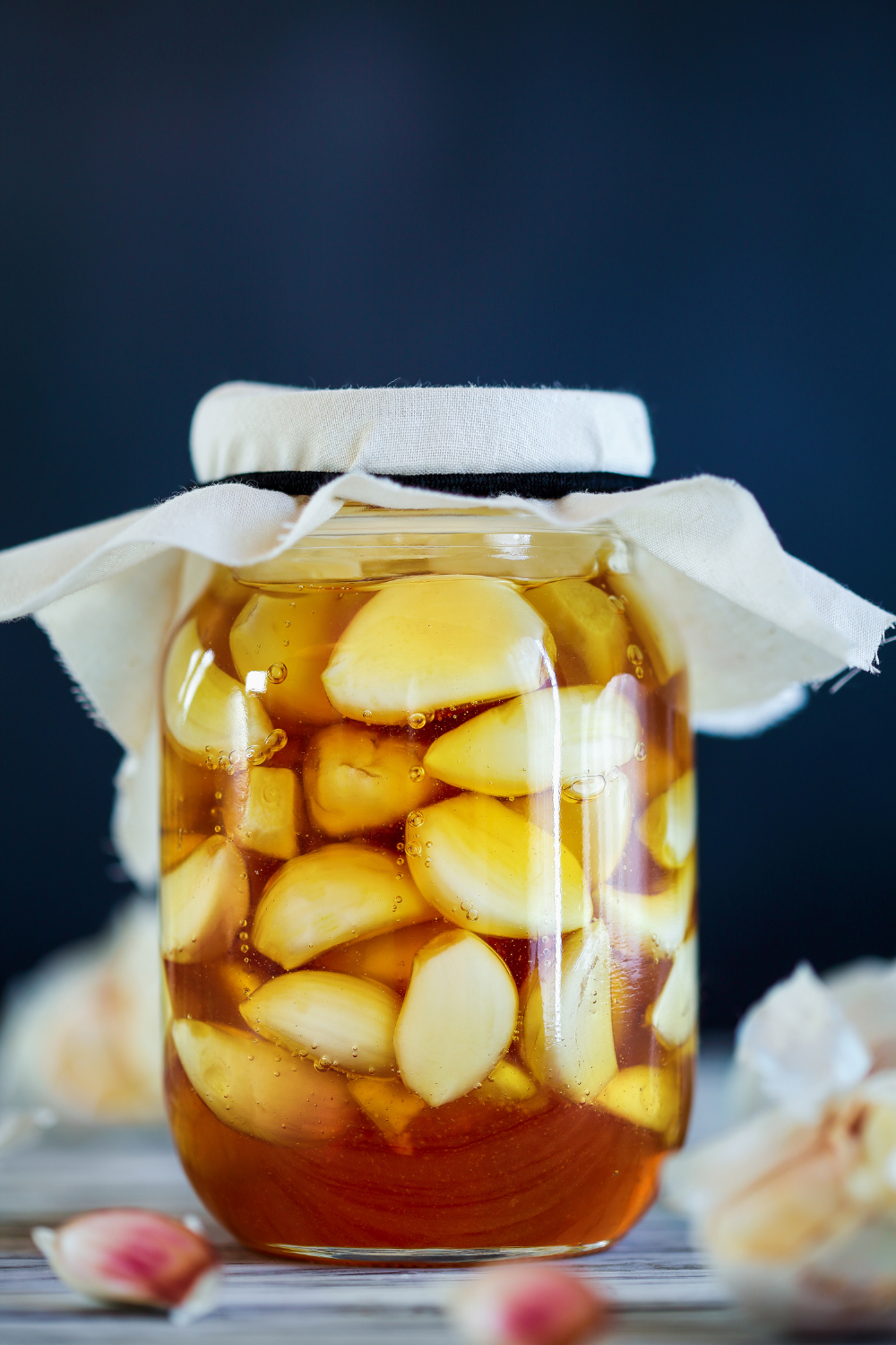 Image illustrates fermented honey garlic for health benefits of garlic.