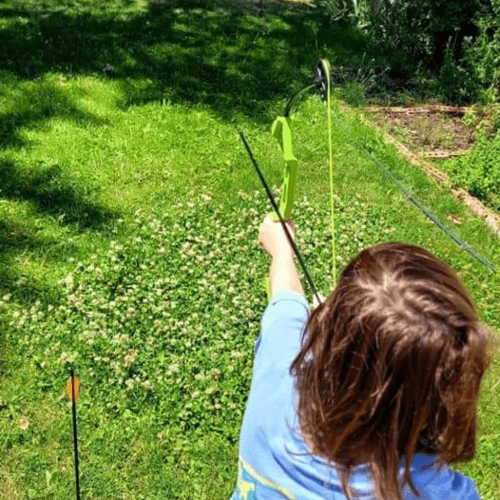 Image illustrates archery for kids from The Off Grid Barefoot Girl.