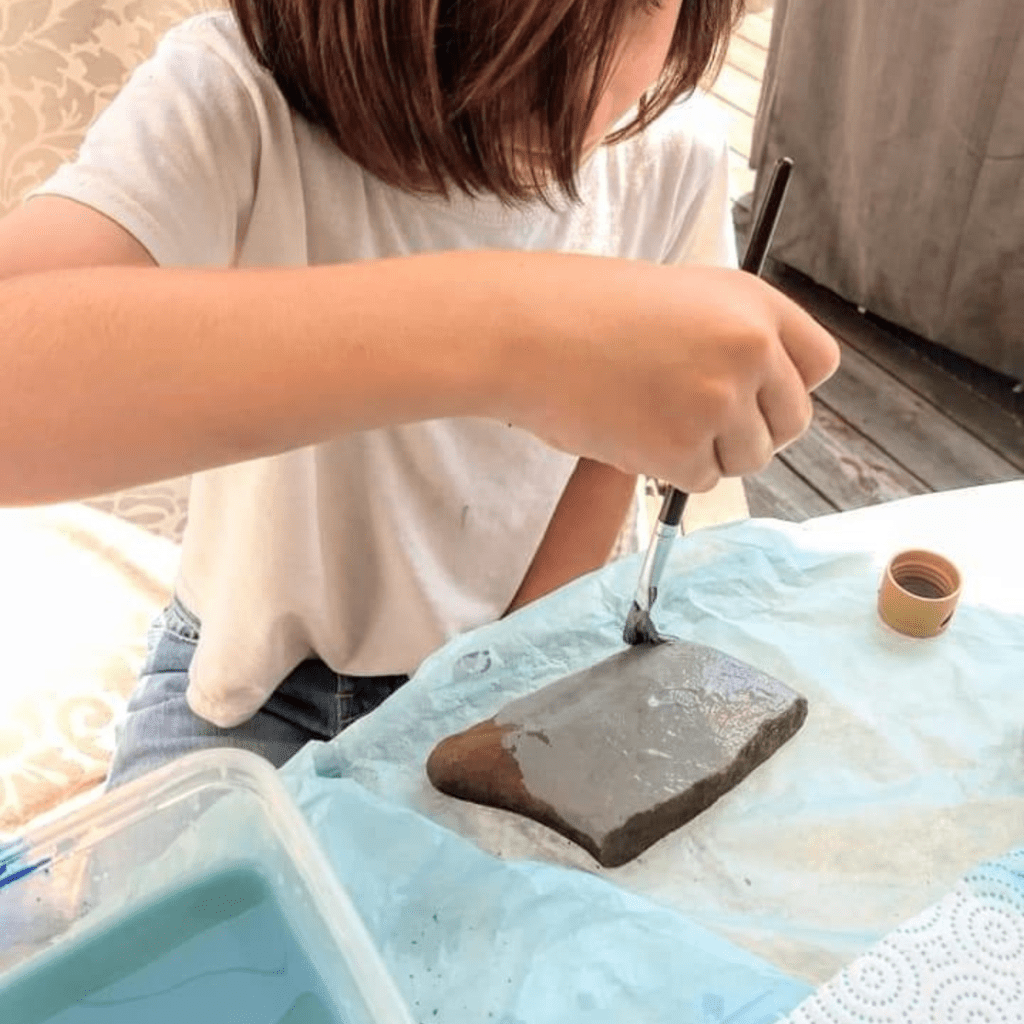 Image illustrates rock painting with kids.
