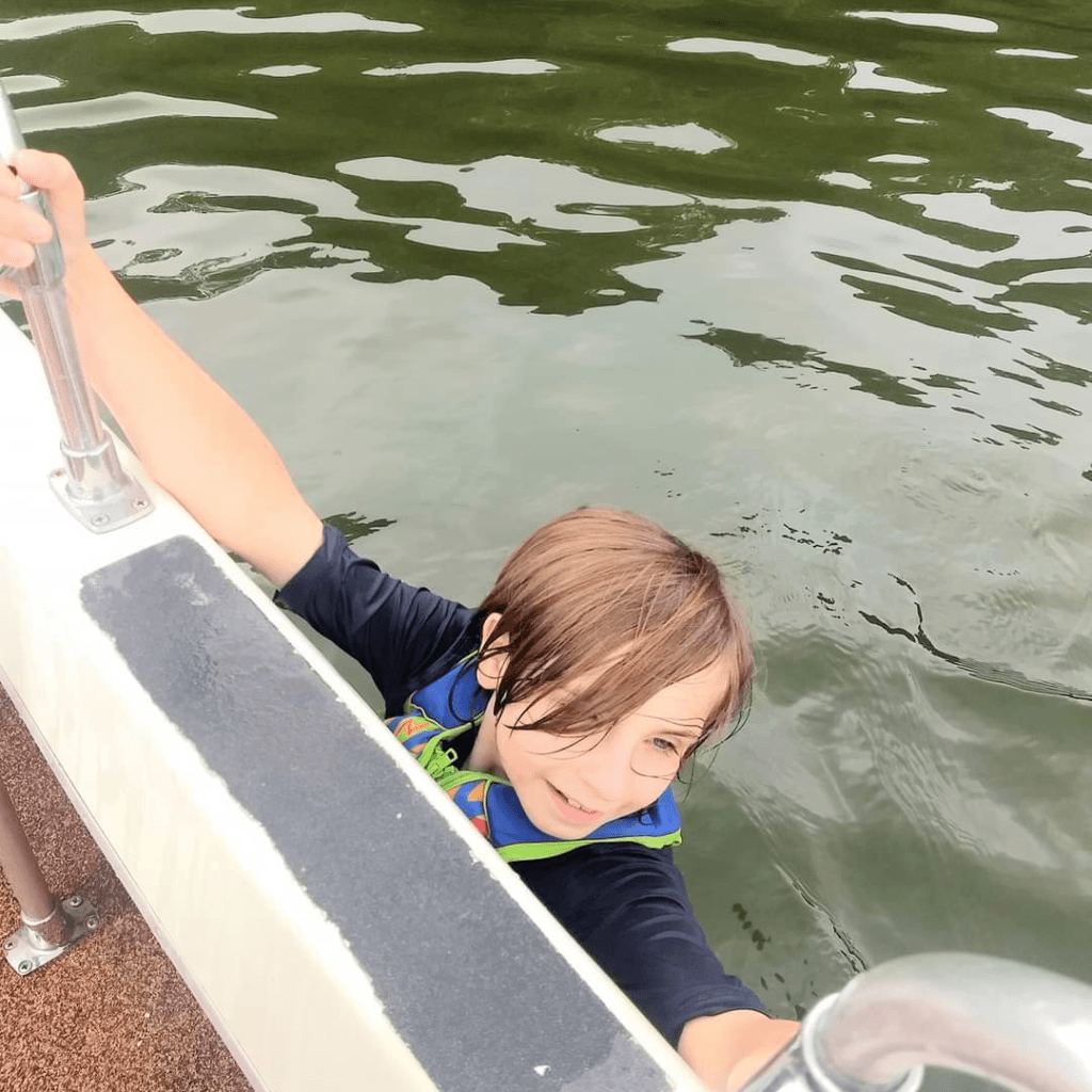Image illustrates an image of a kid going overboard to swim.