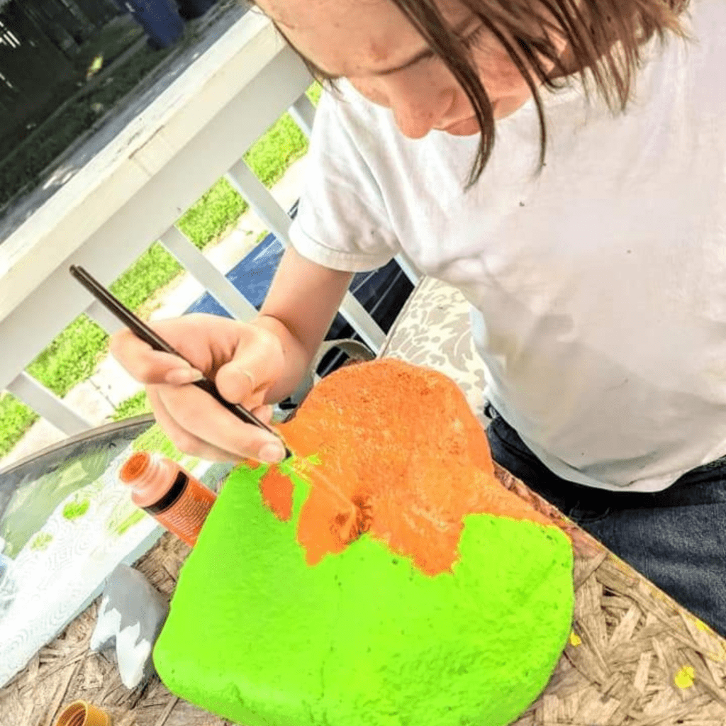 Image illustrates rock painting with kids.