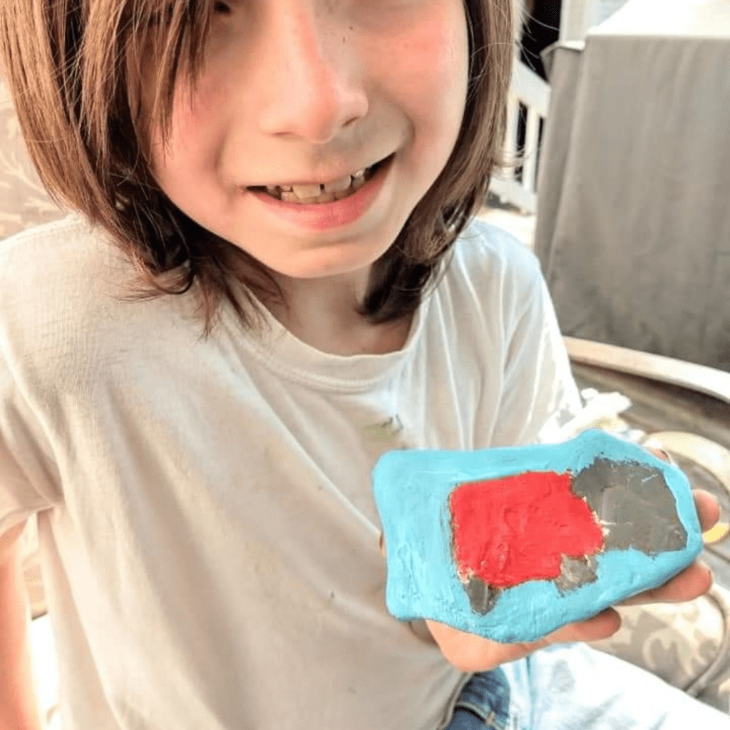 Image illustrates rock painting with kids.