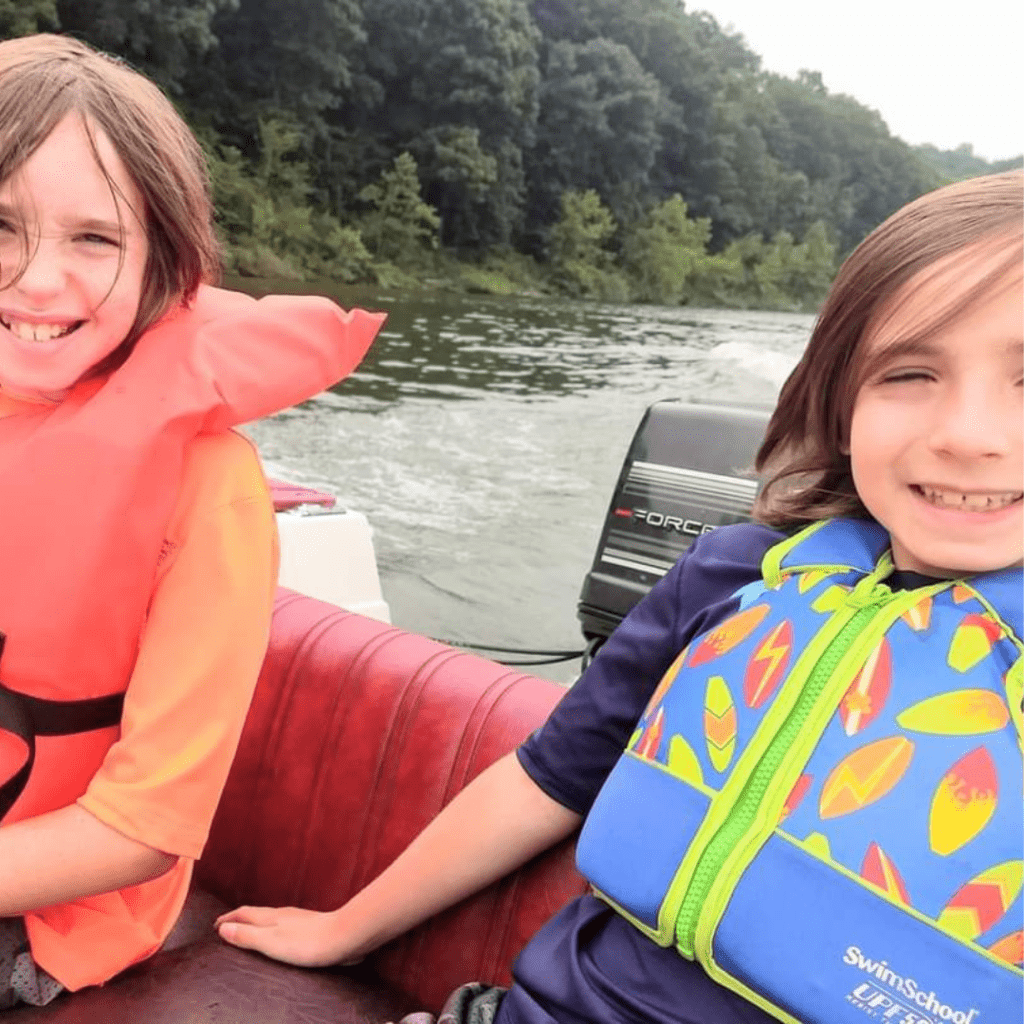 Image illustrates an image of kids on a boat for lake fishing with kids.
