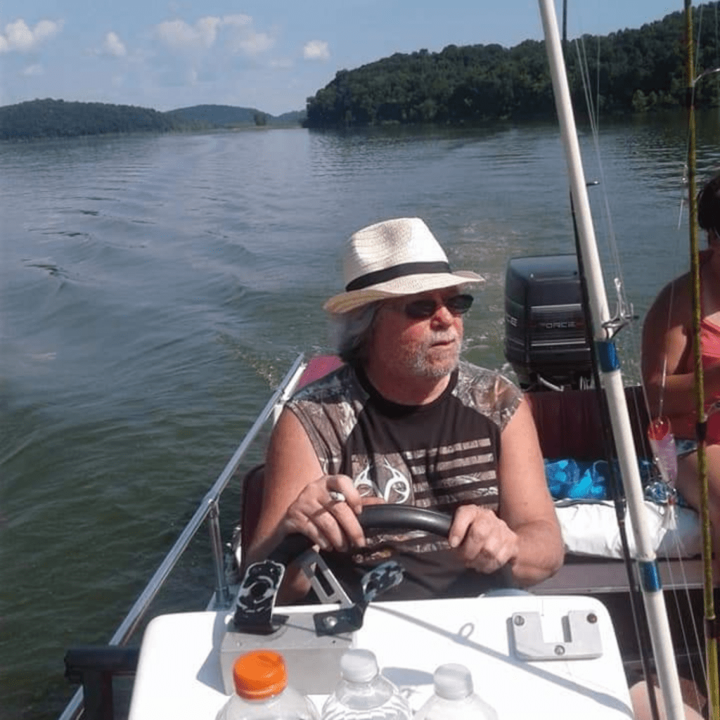 Image illustrates an image of a man on a boat for lake fishing with kids.