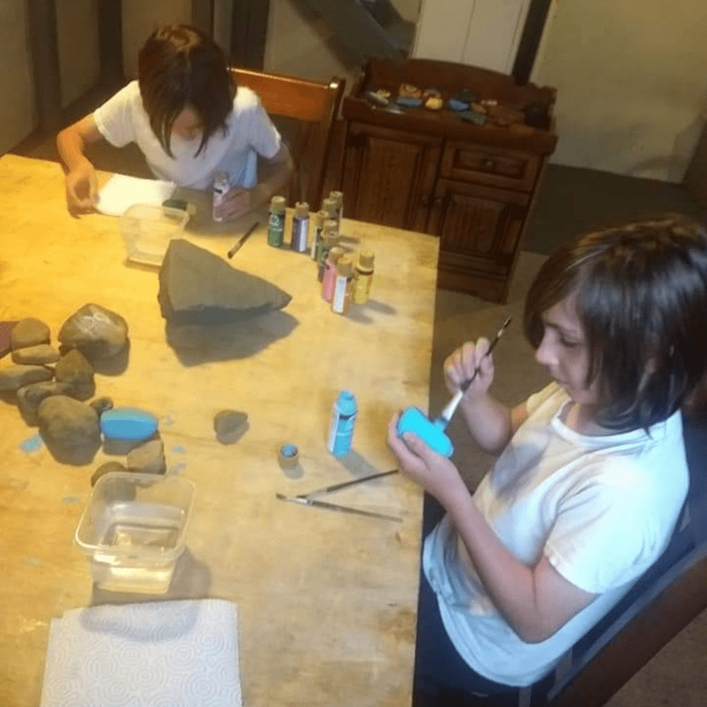 Image illustrates rock painting with kids.