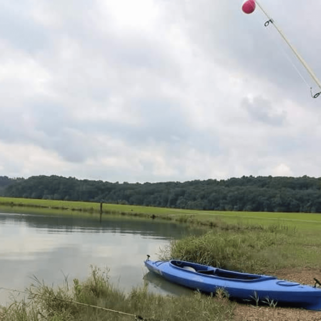 Image illustrates an image of a kayak by a lake.