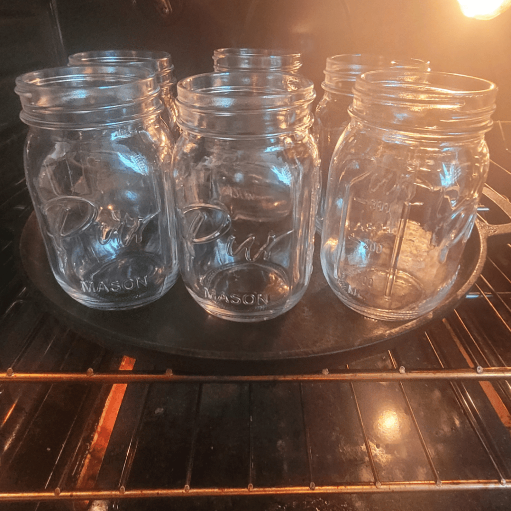 Image illustrates an oven of glass Mason jars. 