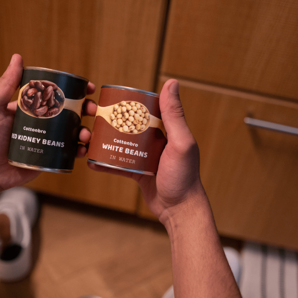 Image illustrates inspecting canned food items to demonstrate how to open a can of food with your bare hands.