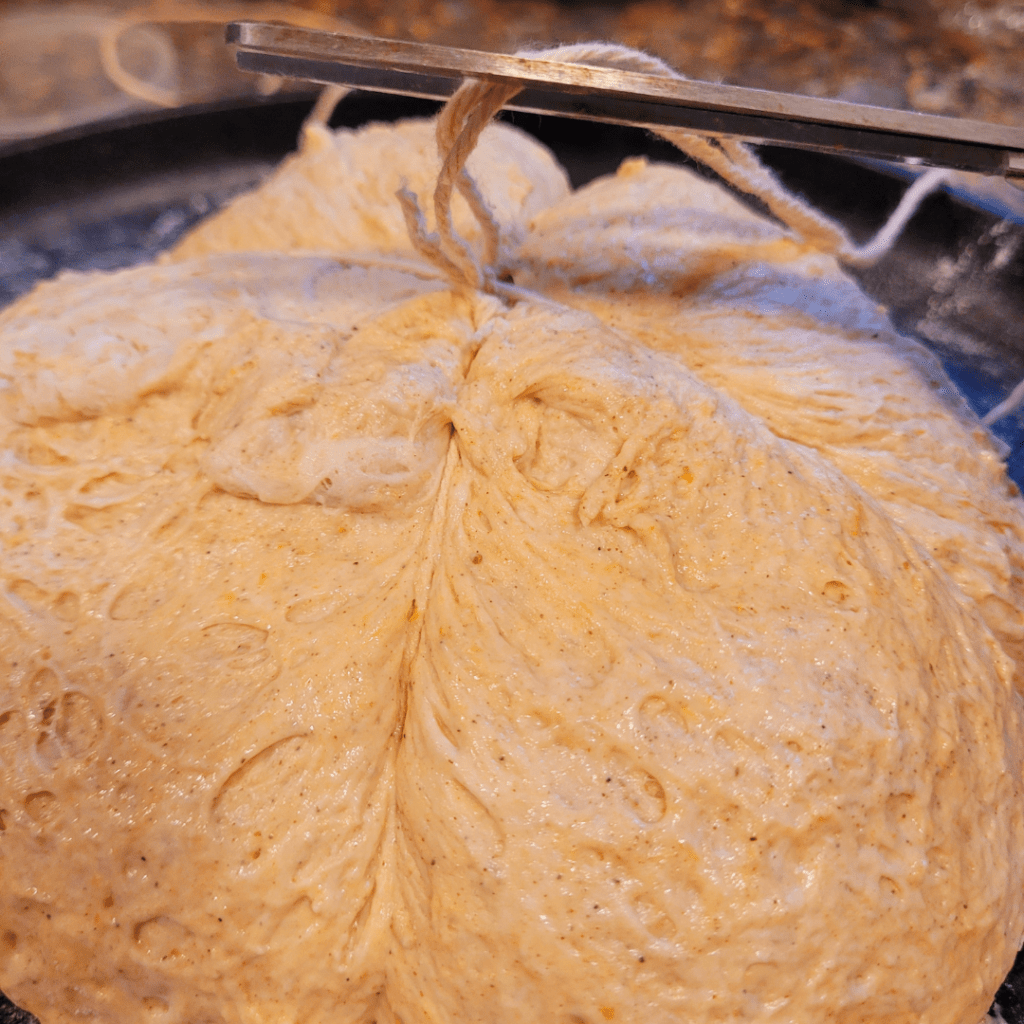Image illustrates a pumpkin-shaped sourdough bread proofing.