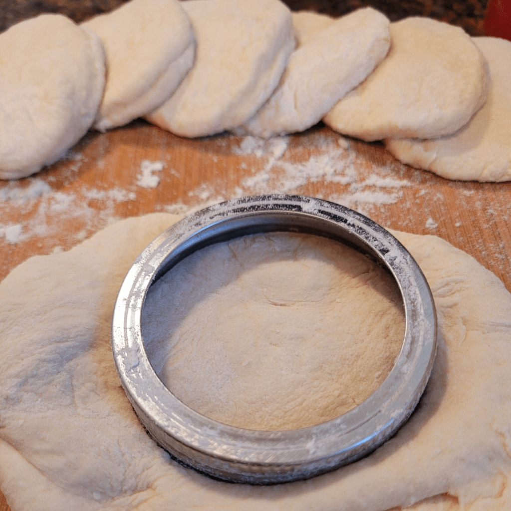 Image illustrates fry bread dough rolled and cut out. 