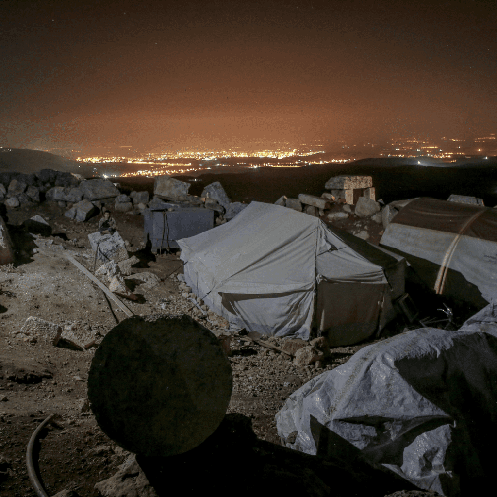 Image illustrates a homeless camp site for homeless survival hacks.