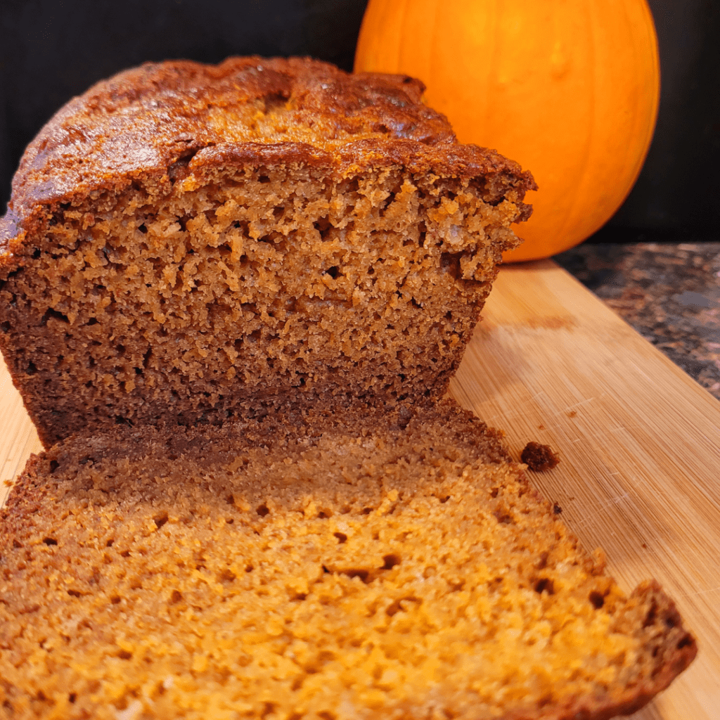 Image illustrates pumpkin bread with a pumpkin for a pumpkin bread recipe.