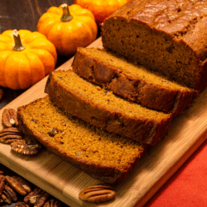Image illustrates pumpkin bread with a pumpkin for a pumpkin bread recipe.