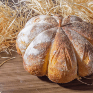Image illustrates a pumpkin-shaped loaf of bread.