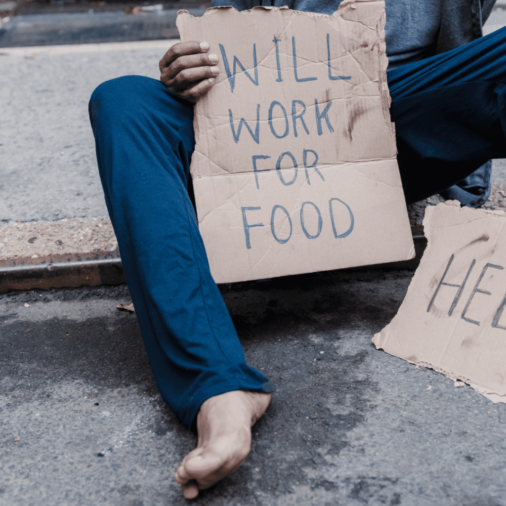 Image illustrates a homeless person with a cardboard sign demonstrating homeless survival hacks.
