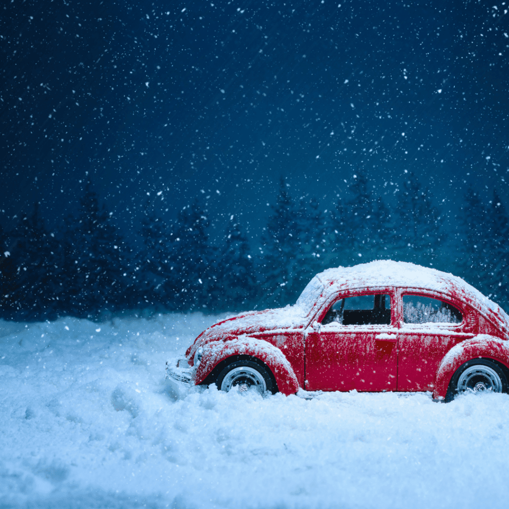Image illustrates a car in snow for demonstrating the importance of winter emergency car kits.