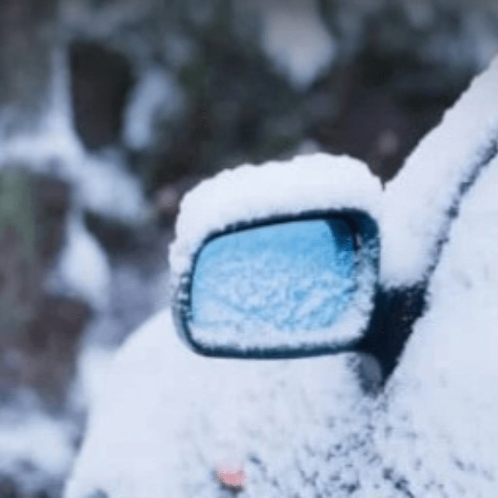 Image illustrates a car driving in a winter storm.