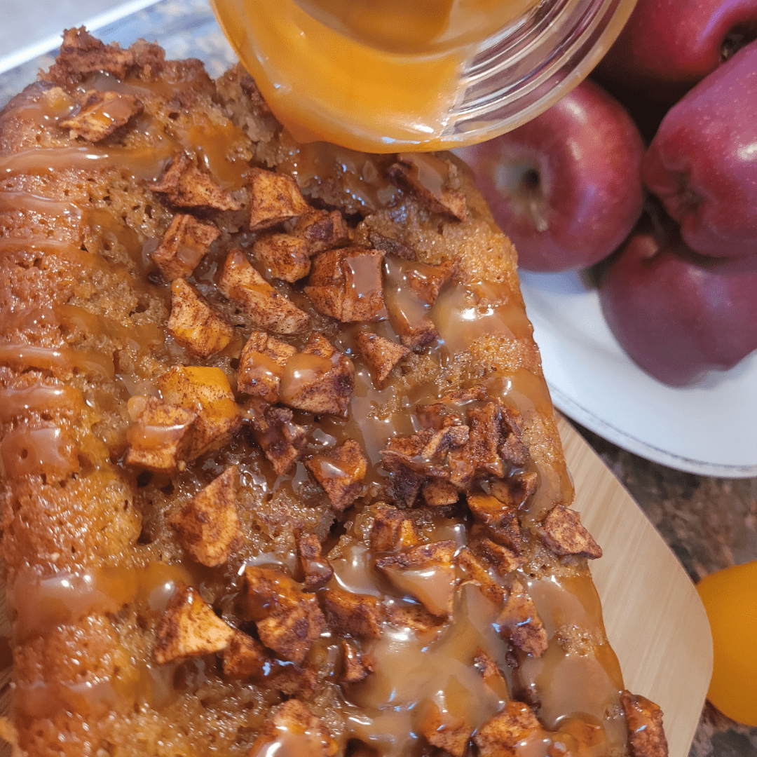 Image illustrates apple fritter bread being drizzled with caramel sauce.