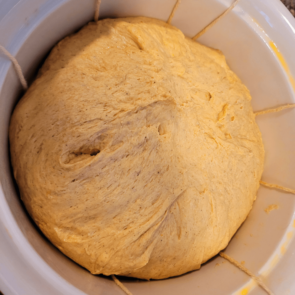 Image illustrates cotton string and bread dough for tying a pumpkin-shaped sourdough bread.