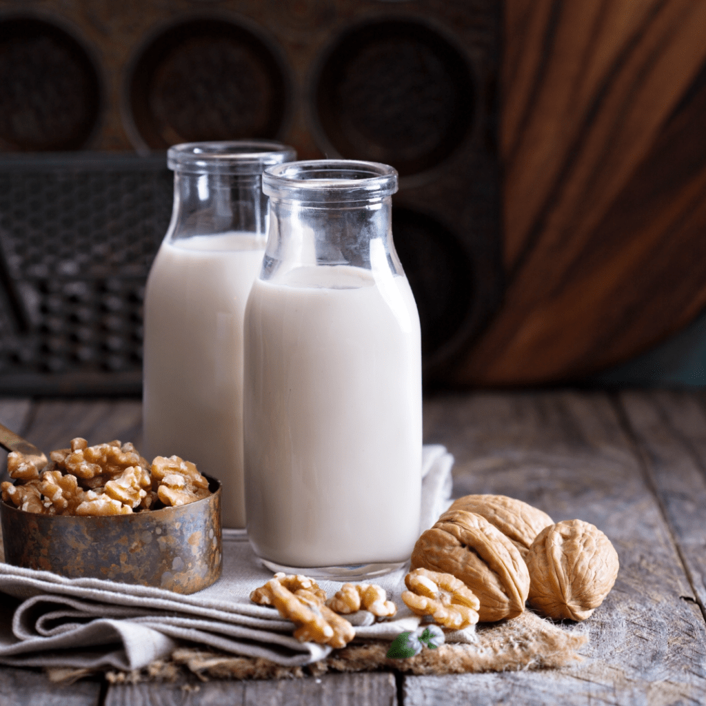Image illustrates vegan milk demonstrating how to stock a vegan pantry.