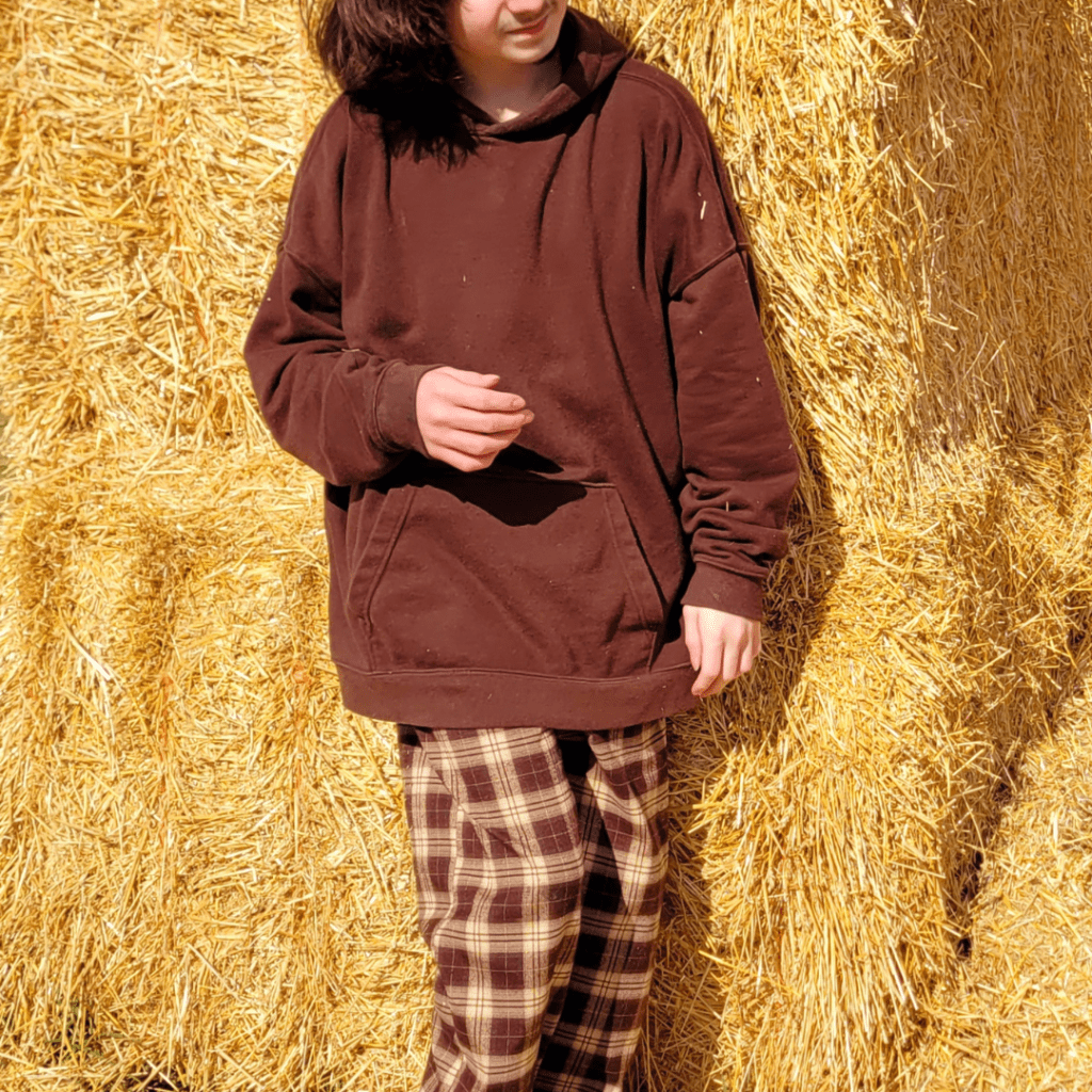 Image illustrates a boy dressed for a perfect day at a farm.
