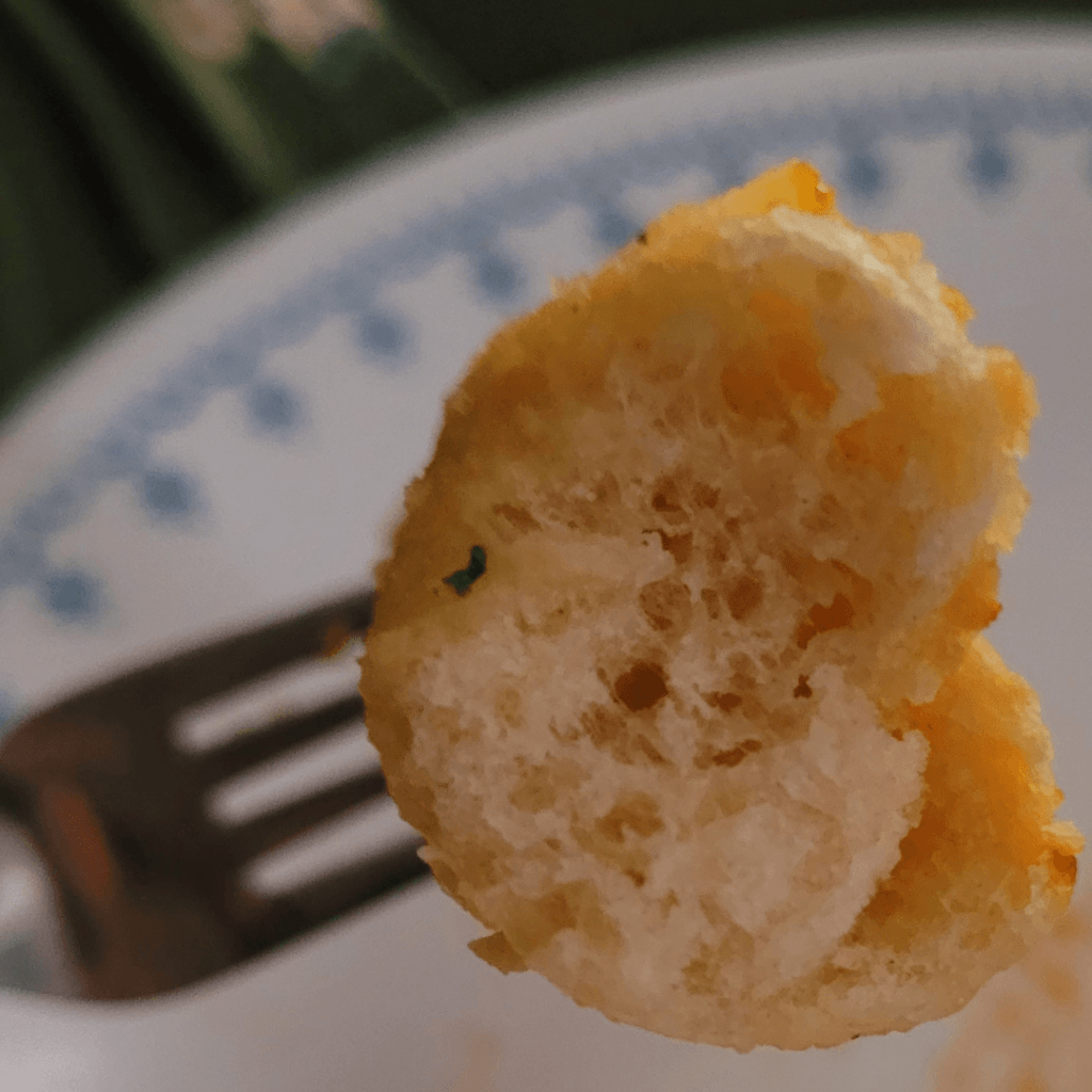 Image illustrates a breadstick on a fork.