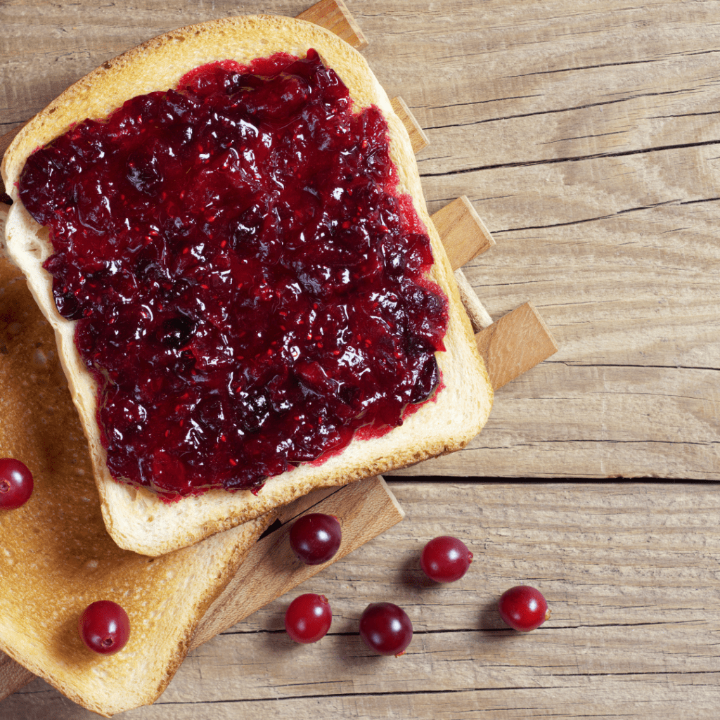 Image illustrates toast and jam for a cranberry merry jam recipe.