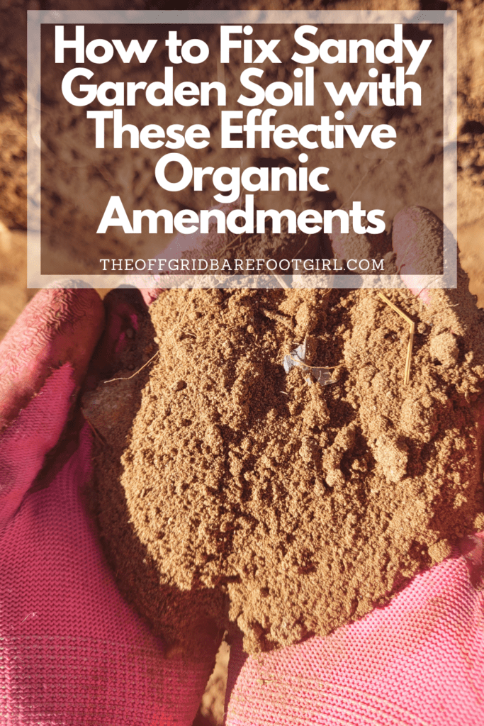 Image illustrates a Pinterest pin of a handful of sandy soil demonstrating how to fix sandy garden soil. 