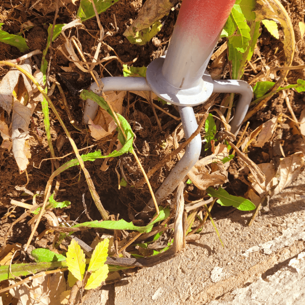 Image illustrates a garden hand tiller demonstrating information on how to use the hand twist claw tiller.