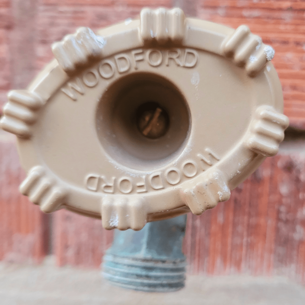 Image illustrates an outdoor faucet. 