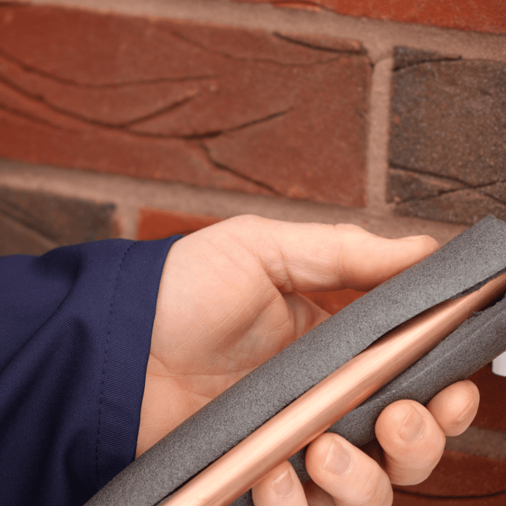 Image illustrates insulating a pipe demonstrating information on how to winterize your home. 