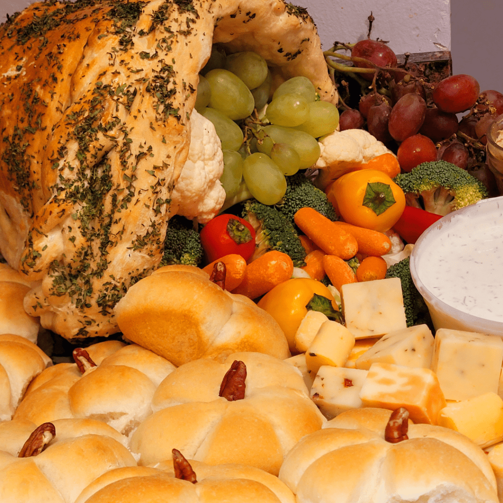 Image illustrates pumpkin-shaped rolls with pecan stem presented with a breaded cornucopia. 