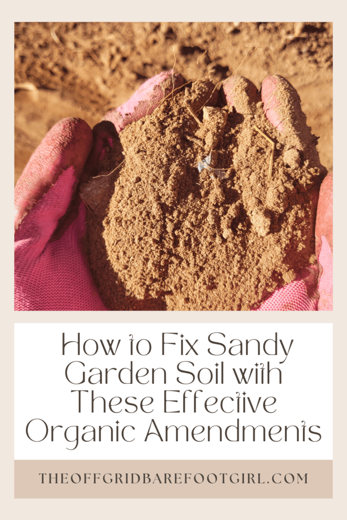 Image illustrates a Pinterest pin of a handful of sandy soil demonstrating how to fix sandy garden soil. 