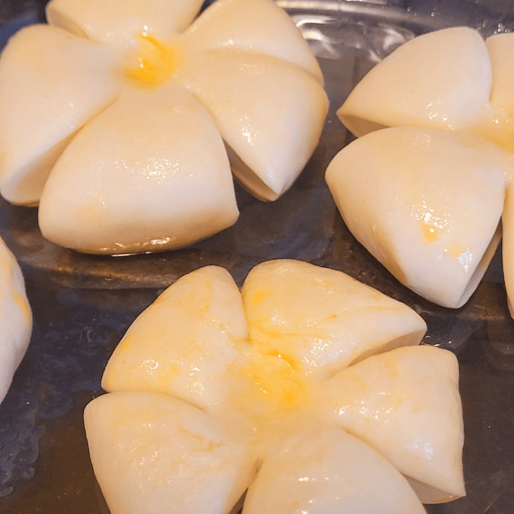 Image illustrates pumpkin-shaped rolls. 