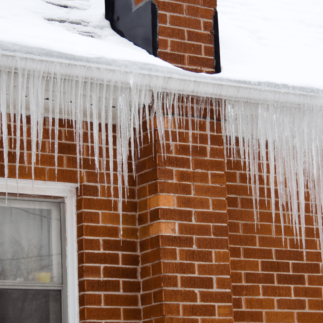 Image illustrates a brick house with icicles demonstrating how to winterize your home.
