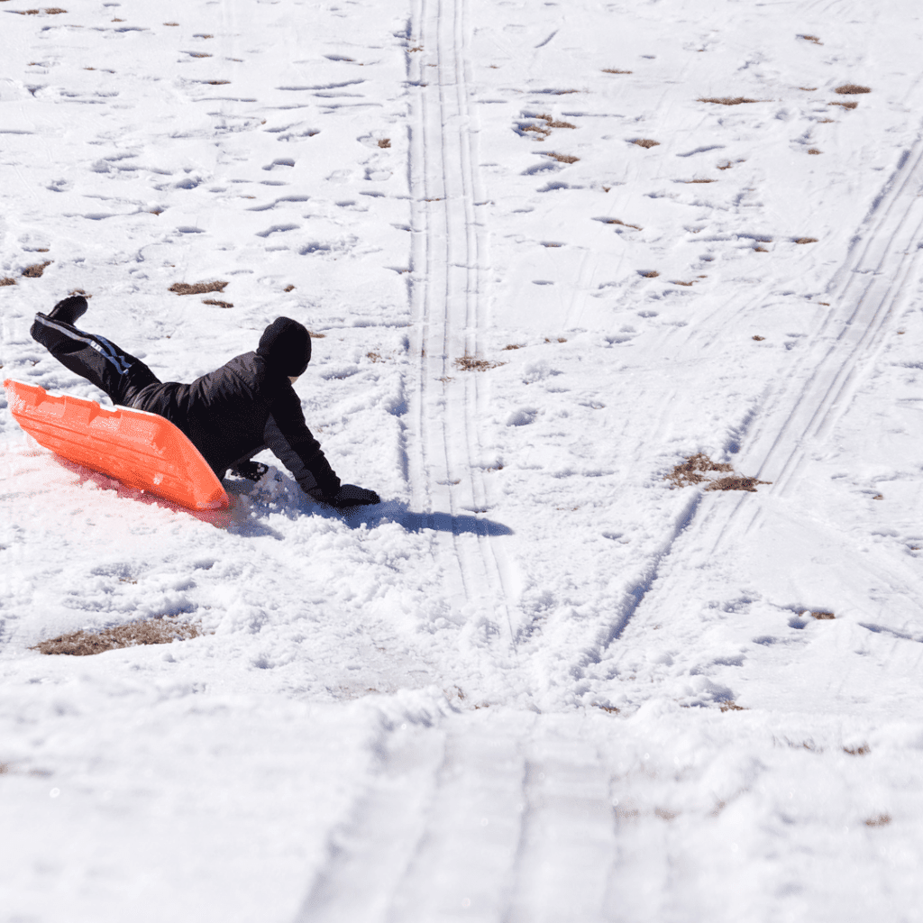 Image illustrates a sledder sled riding.