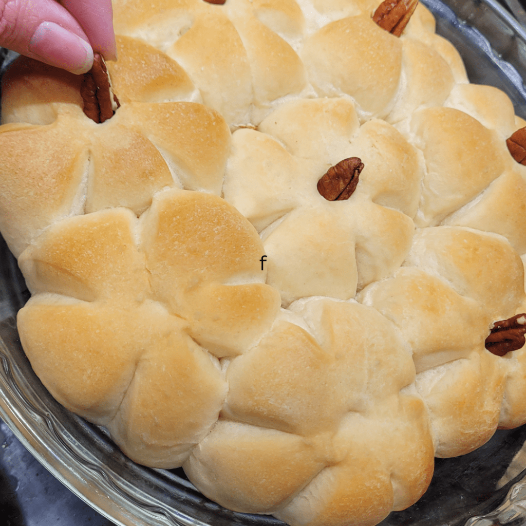 Image illustrates pumpkin-shaped rolls with pecan stems. 