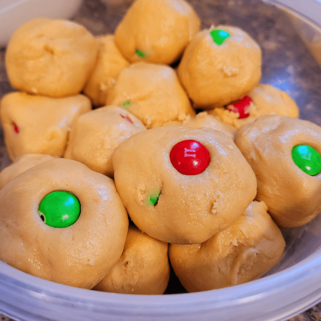 Image illustrates cookie dough in an airtight container. 