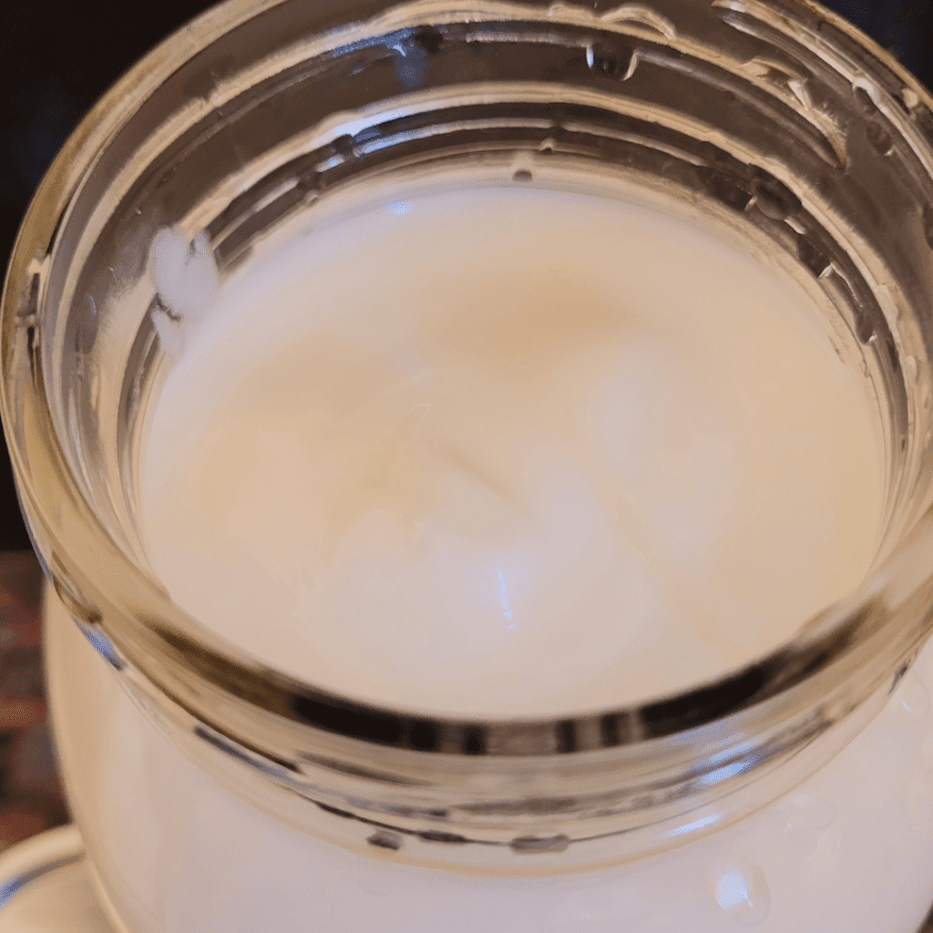 Image illustrates a Mason jar with buttermilk demonstrating a recipe on how to make homemade cultured buttermilk. 